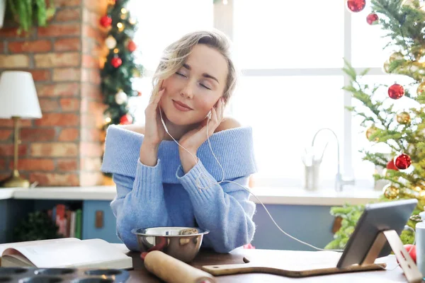 Christmas. Beautiful woman at the kitchen in the morning