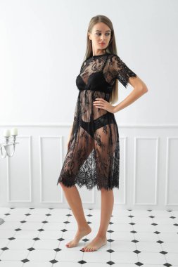 Güzel kız siyah elbiseyle poz veriyor.