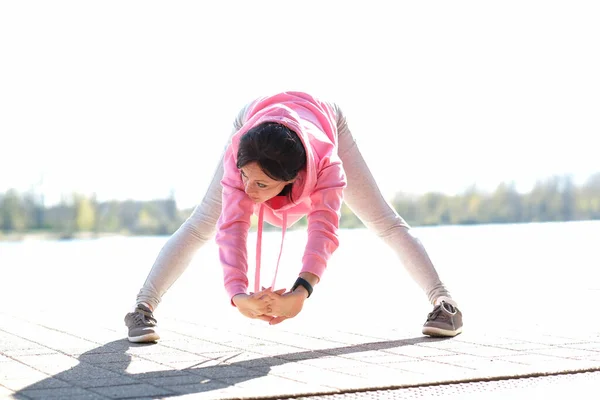 Street sport. Woman is exercising outdoor