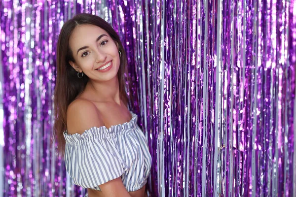 Beautiful girl by the purple rain curtain background