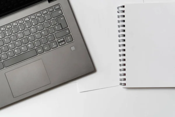 minimalist desk with a laptop and blank papers. Office and business concept