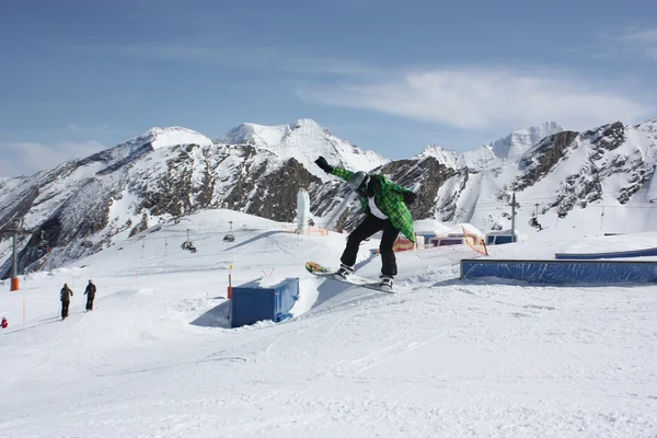 젊은 snowboarder 남자 상자에 슬라이딩. — 스톡 사진