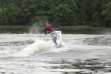Action Photo Man on seadoo. A view from the back. clipart