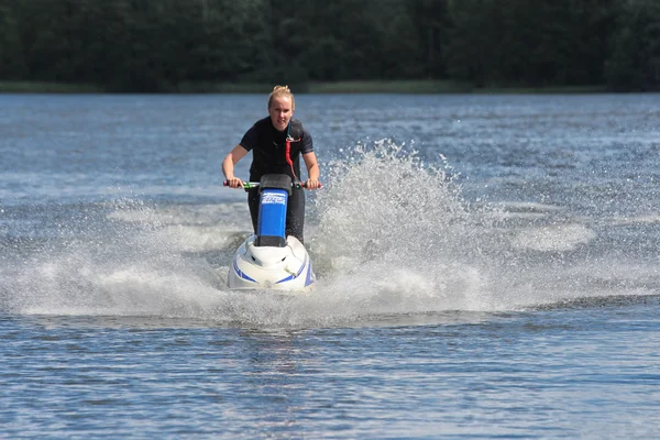 Action Photo young woman on jet ski. – stockfoto