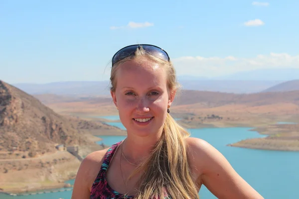 The portrait of young woman on the Barrage Al massira, big water storage in Morocco, background. — Stock Photo, Image