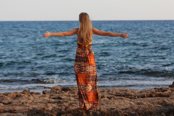 Молодая красивая девушка стоит в стороне и раскидывает руки
.