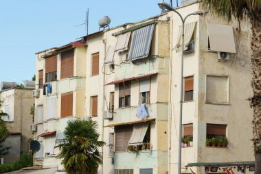 Akdeniz yumuşaklığı, düz çatı çizgileri, çerçeveli balkonları olan geleneksel Arnavut tarzı bir cephe. Kiralama veya satın alma, taşınma ihtiyaçları, ajans listeleri ve tatil hayatı için ideal.