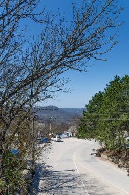 Deniz manzaralı güzel bir dağ manzarası. Dağlarda dolambaçlı bir yol, Kırım. Seyahat ve tatil kavramı.