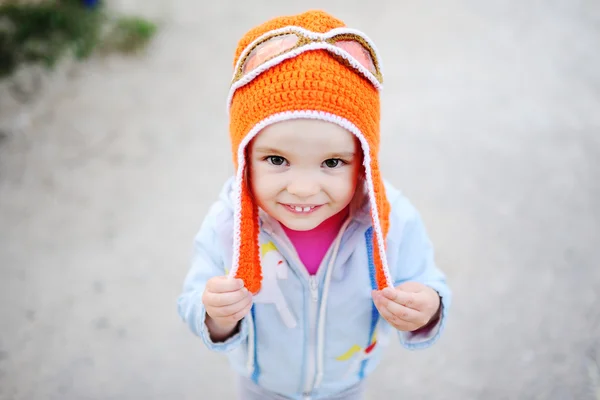 Baby girl in pilot hat smiling at the camera — Stock Photo, Image