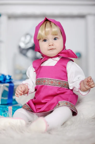 Baby girl in Russian national dress and a scarf on her head sitt — Stock Photo, Image
