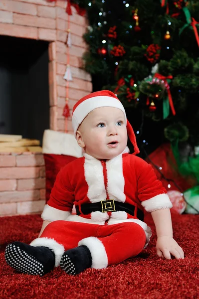 Baby boy dressed as Santa Claus. Boy in a Santa suit on the back — Stock Photo, Image