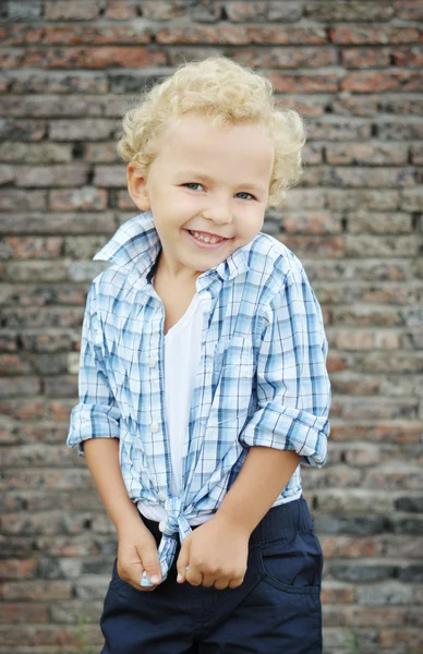 Curly-haired jongen in het shirt glimlachen — Stockfoto