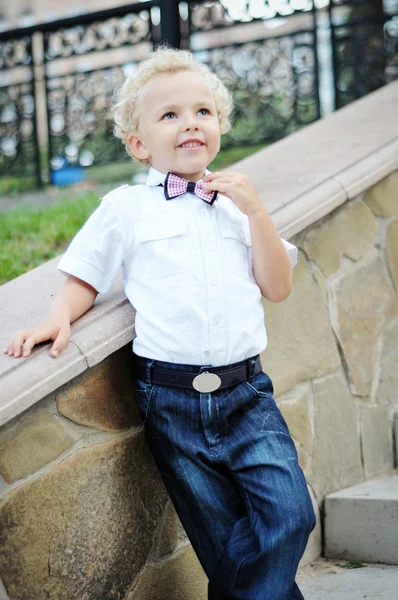 Curly child bow tie smiling — Stock Photo, Image