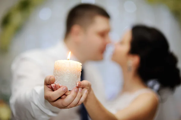 A noiva eo noivo estão segurando uma bela vela — Fotografia de Stock