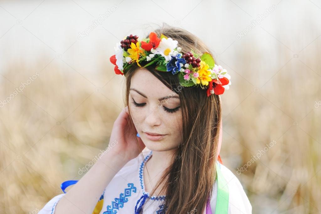 Girl in the Ukrainian national shirt and floral wreath on her head