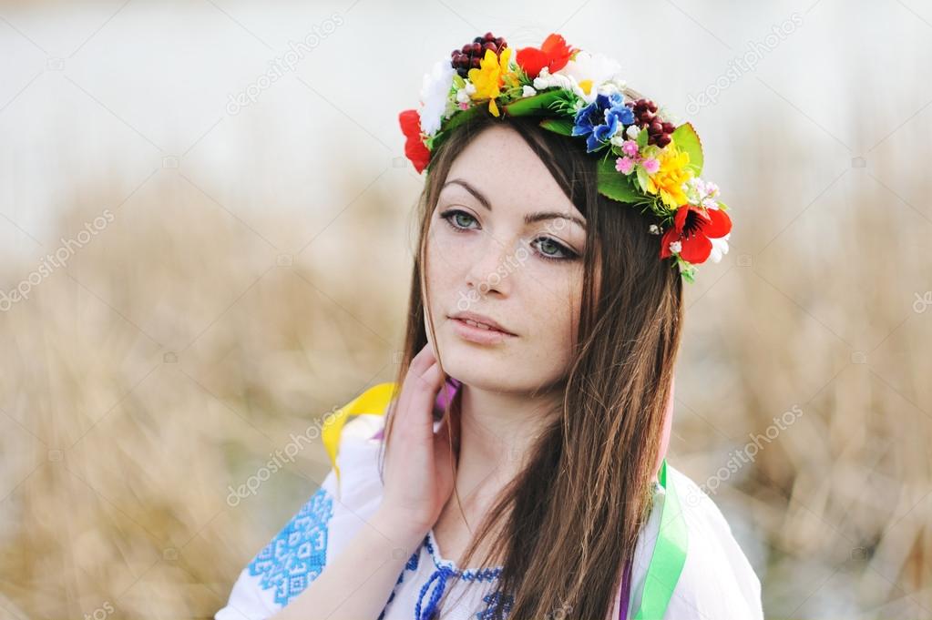 girl in the Ukrainian national shirt and floral wreath on her he