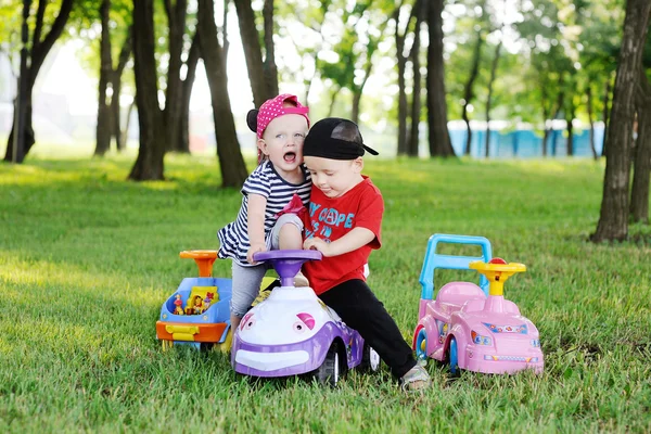 little boy and girl quarrel over a toy car