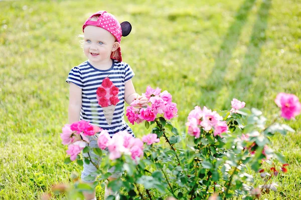 Bayi perempuan di latar belakang mawar — Stok Foto