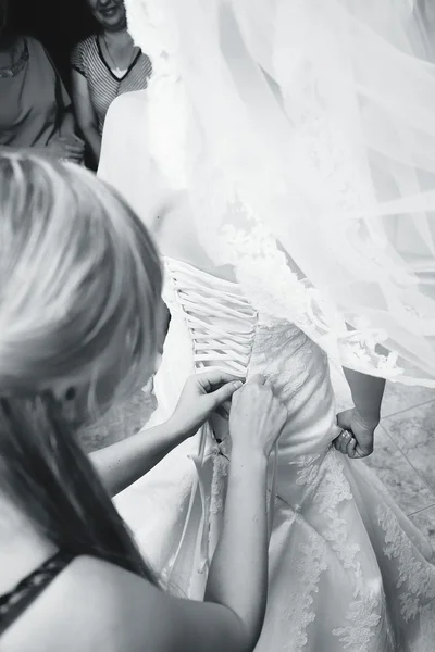 Bridesmaid corset laces on a wedding dress — Stock Photo, Image