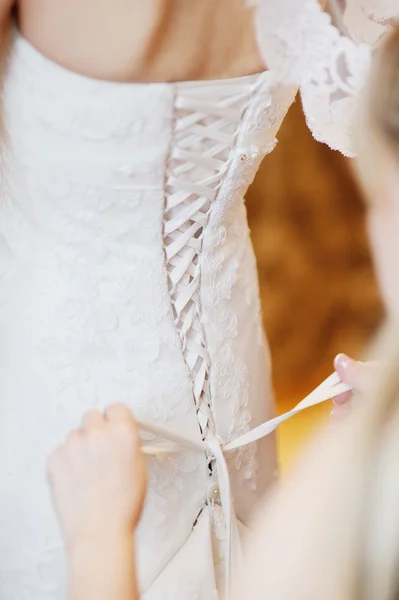 Bridesmaid corset laces on a wedding dress — Stock Photo, Image