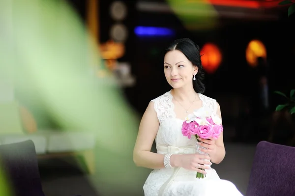 Beautiful bride with a wedding bouquet of orchids