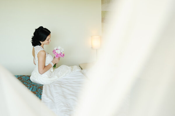 Beautiful bride with a wedding bouquet of orchids