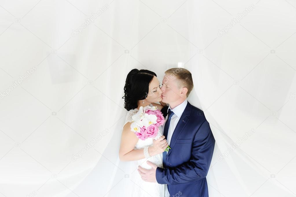 the bride and groom on a white background. the bride with a wedd