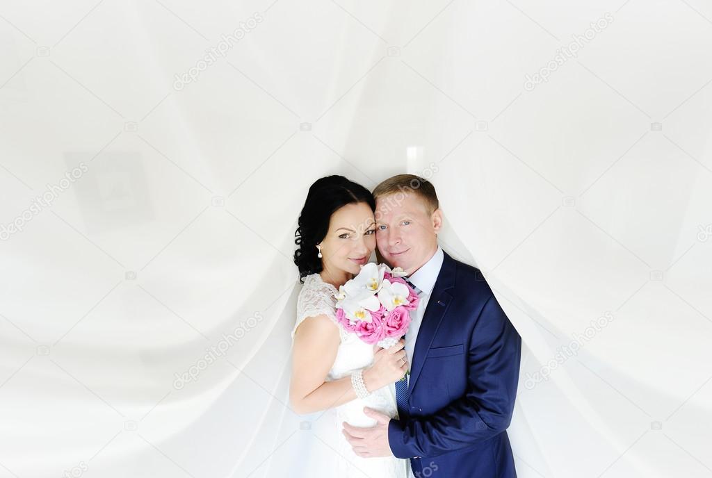 the bride and groom on a white background. the bride with a wedd