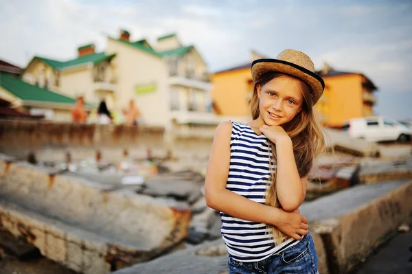 Krásná dospívající dívka v pruhované košili a klobouk na pozadí — Stock fotografie