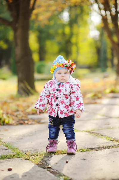 Маленька дівчинка з різнокольоровим обручем на голові на фоні авгу — стокове фото