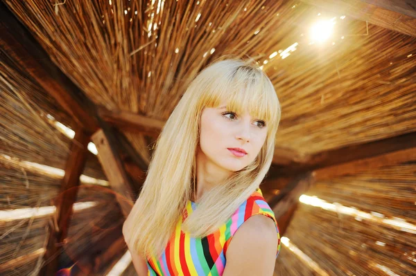 Girl in a colorful sundress on the beach — Stock Photo, Image