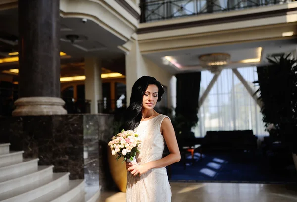 Bride with a wedding bouquet in the background Interior — Stock Photo, Image