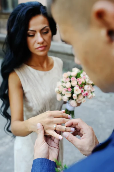 Bride groom wears a wedding ring — Stock Photo, Image