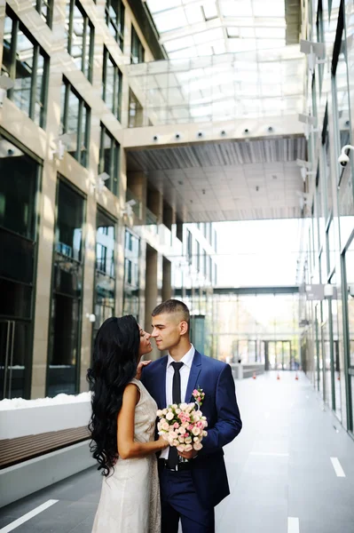 La mariée et le marié sur le fond du bâtiment en verre — Photo