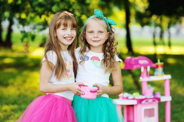 Little girls playing in the kitchen — Stock Photo, Image