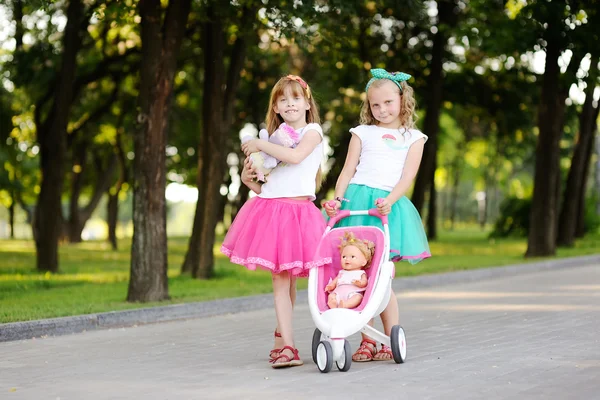 Two little girls play with dolls — Stock Photo, Image