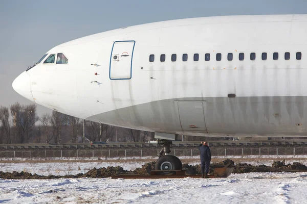 Close up of old unused large passenger plane on a snowy field, will be turned into a museum piece. Decommissioned aircraft.
