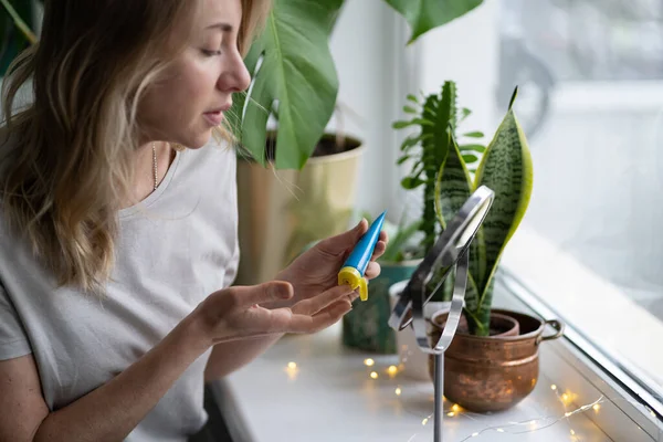 Femme appliquant un baume nourrissant hydratant sur ses lèvres avec le doigt pour prévenir la sécheresse et le gercement — Photo