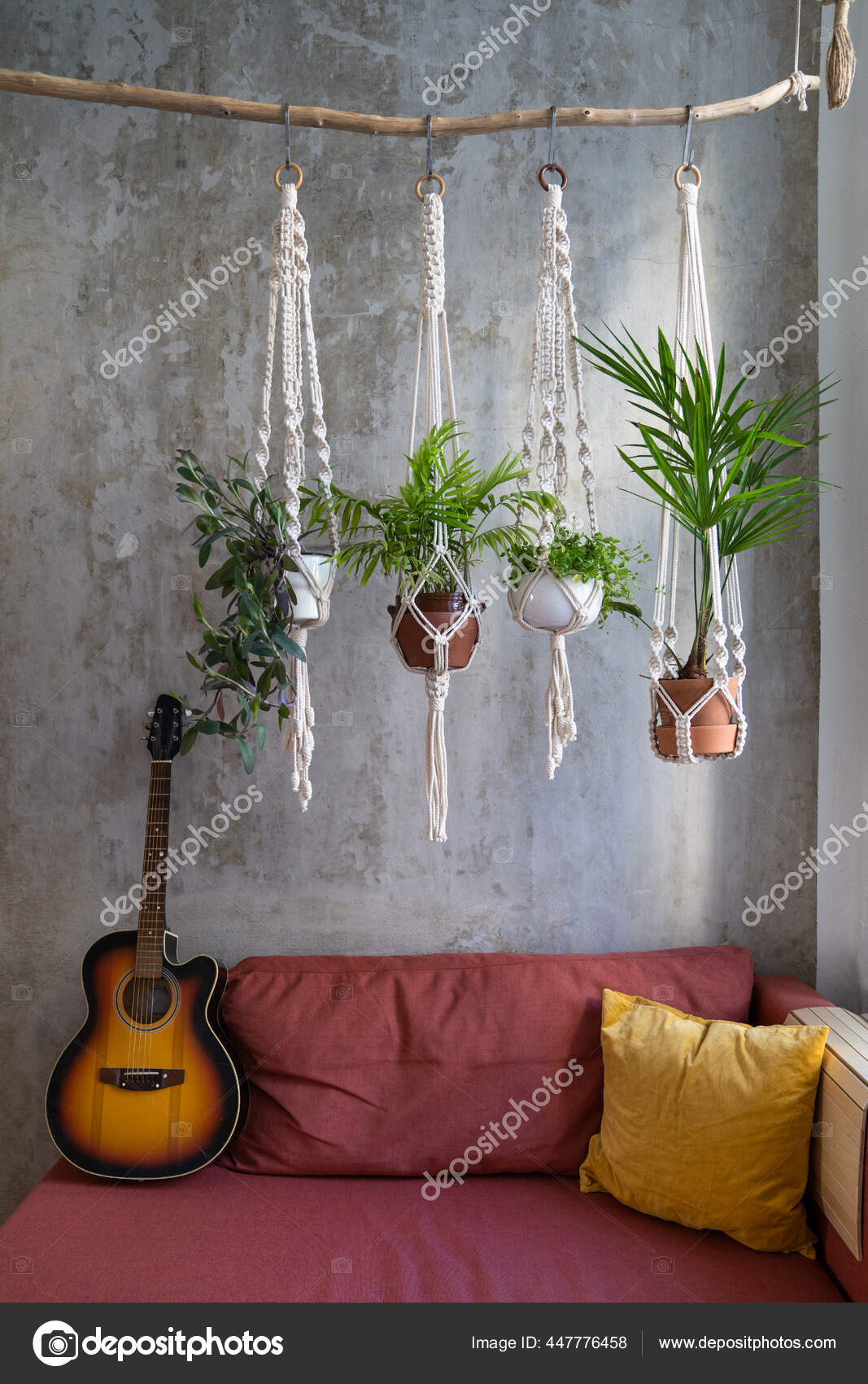 Handgemachter Makramapflanzen-Kleiderbügel, der am Holzzweig hängt