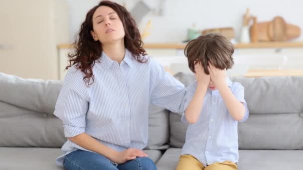 Caring mom supporting little preschool son. Beautiful female parent comforting crying offended kid — Stock Video