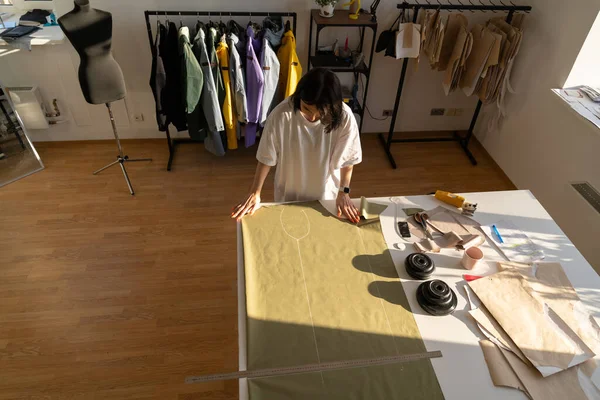 Sewing and cutting process: dressmaker work with patterns on fabric for collection in atelier studio — Stock Photo, Image