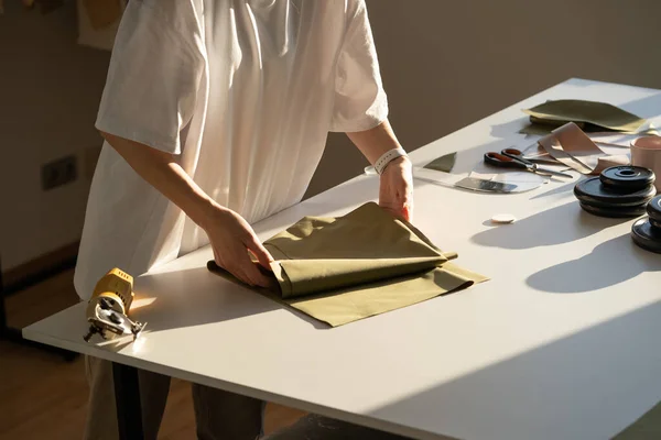 Closeup of female sewer hold fabric to cut working in workshop studio. Creative process in atelier — Stock Photo, Image