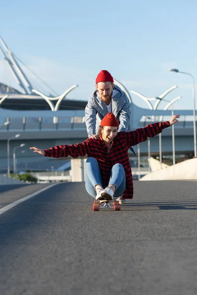 Νεαρό ζευγάρι hipster έχουν τη διασκέδαση σε εξωτερικούς χώρους longboard ιππασία της πόλης δρόμο χαρούμενα γέλια μαζί — Φωτογραφία Αρχείου