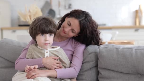 Evde sevimli oğluyla kucaklaşan şefkatli bir kadın aile içi hafta sonunun tadını çıkarıyor. Şefkat ve aşk kavramı — Stok video