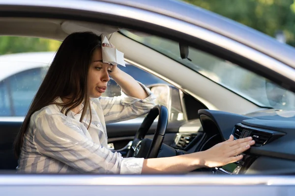 Exhausted young woman suffer from heat inside car with broken air conditioner and hot temperature — Stock Photo, Image