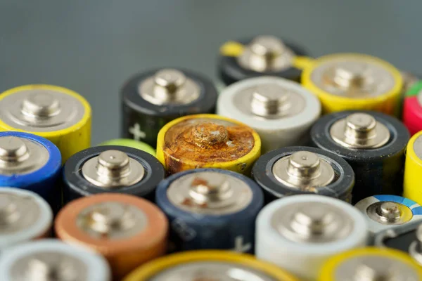 Close up of used battery with traces of rust and corrosion. Electronic hazardous waste concept