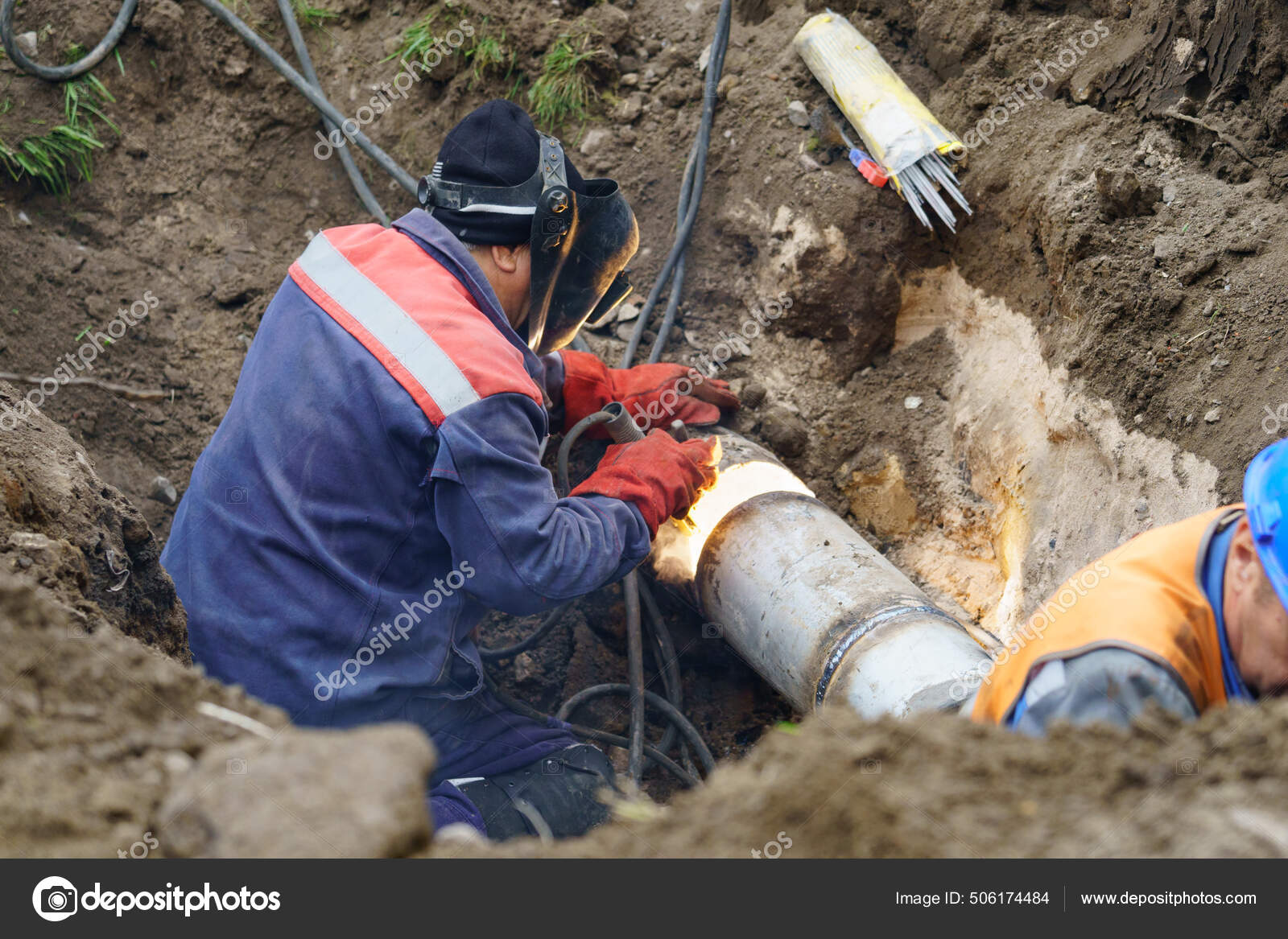 Utility worker fixing broken water main. Sewerage pipe repair