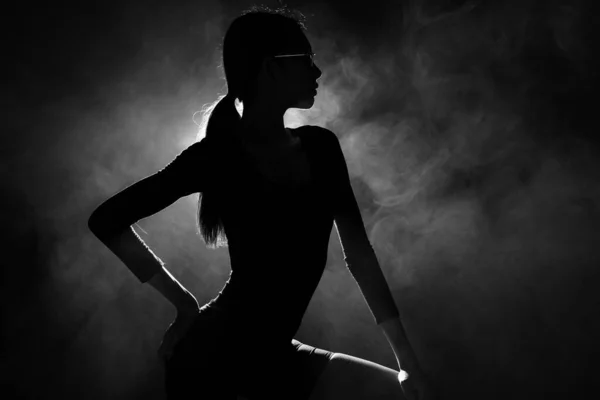Silhouette abstract Portrait of woman to show beautiful Body shape and express feeling. Backlit smoke low exposure dark background copy space