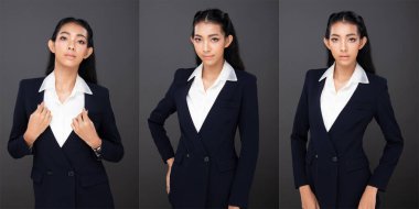 20 'li yaşlardaki Asyalı kadın portresinin yarısı siyah saçlı, pantolon giyiyor. Ofisteki kadın yüz ifadeleri ve gri arkaplanda izole edilmiş kameraya bakıyorlar.