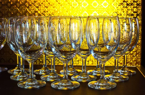 Many Empty Wine Glass Order Table Yellow Back Light Glass — Stock Photo, Image